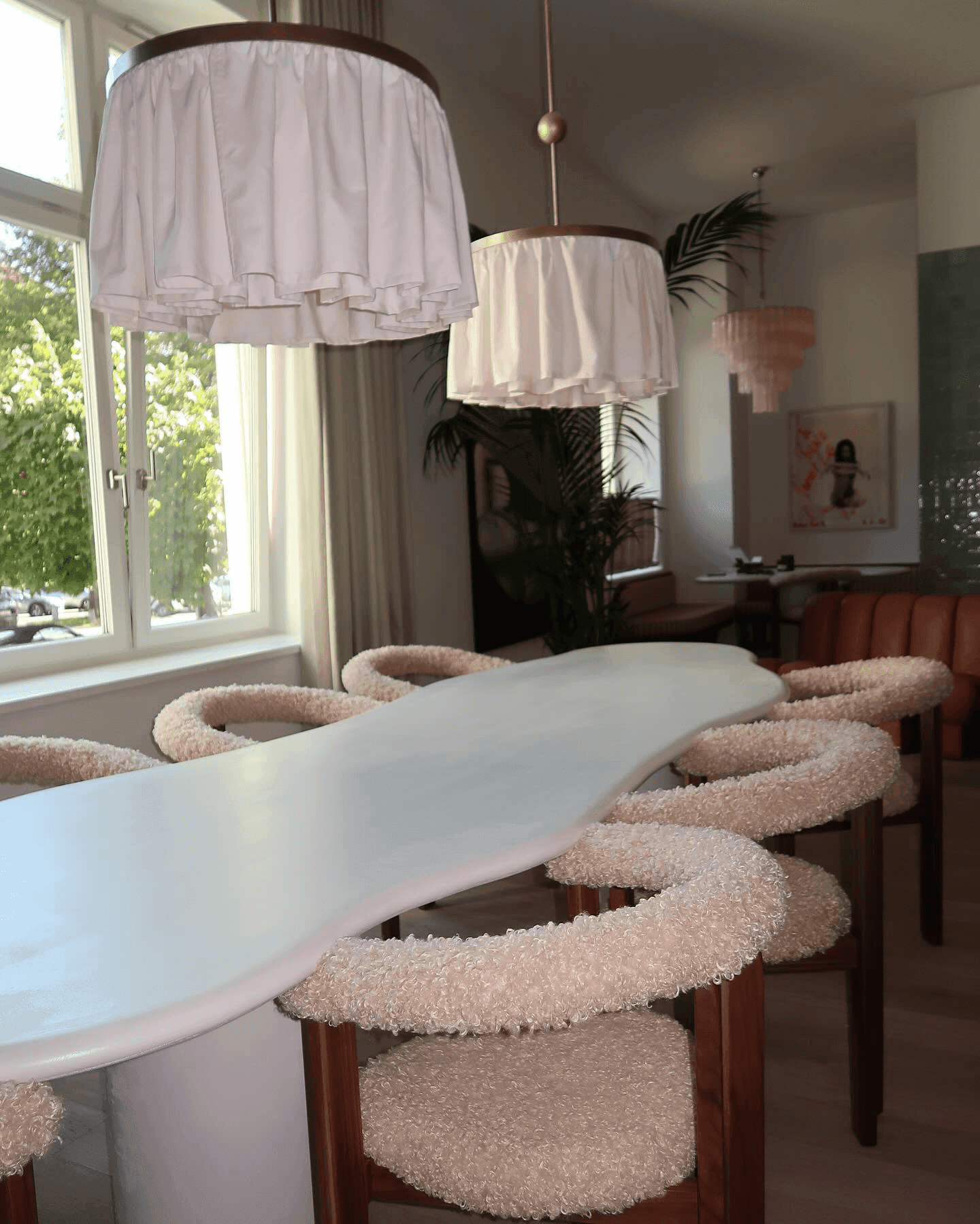 Dining room with textured chairs and pendant light